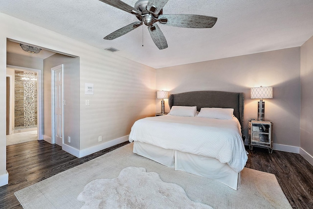 bedroom featuring visible vents, wood finished floors, baseboards, ceiling fan, and a textured ceiling