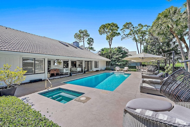 view of pool featuring an in ground hot tub, a patio area, and an outdoor hangout area