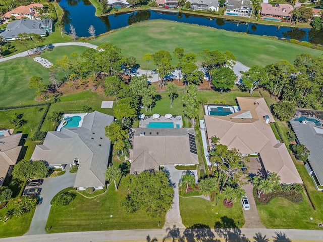 drone / aerial view with a water view, a residential view, and golf course view