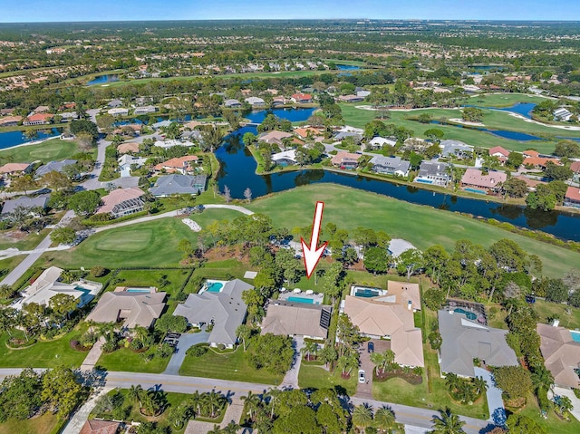 drone / aerial view with a residential view, a water view, and golf course view