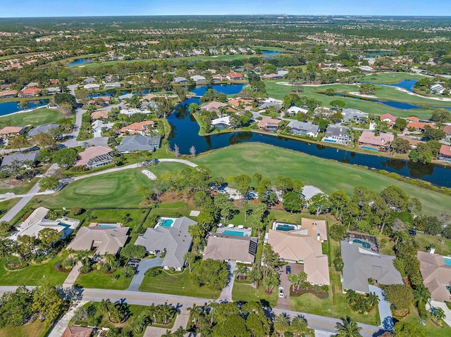 birds eye view of property featuring a water view, view of golf course, and a residential view