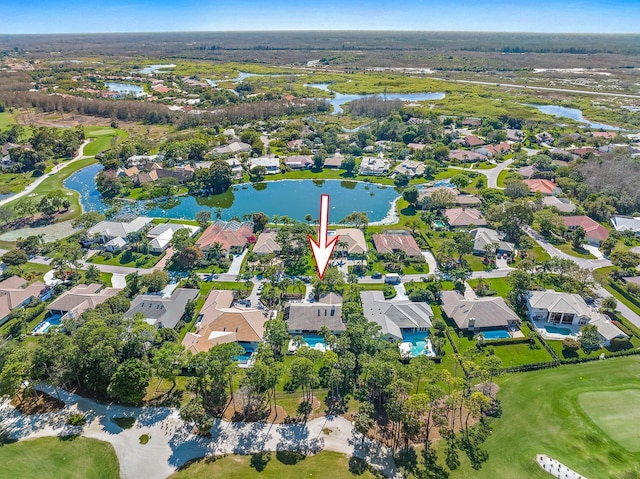 drone / aerial view featuring a residential view, a water view, and golf course view
