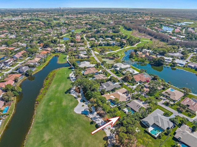 bird's eye view featuring a water view, view of golf course, and a residential view