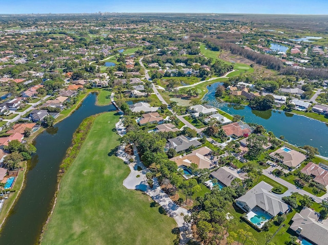 drone / aerial view with a water view, a residential view, and golf course view