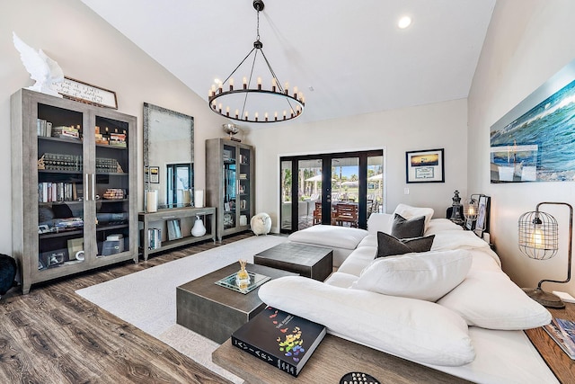 living room featuring french doors, wood finished floors, a chandelier, and high vaulted ceiling