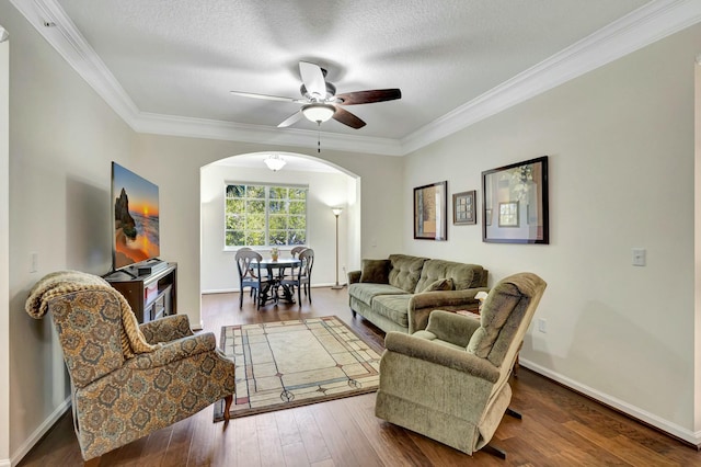 living room with arched walkways, a textured ceiling, wood-type flooring, and crown molding