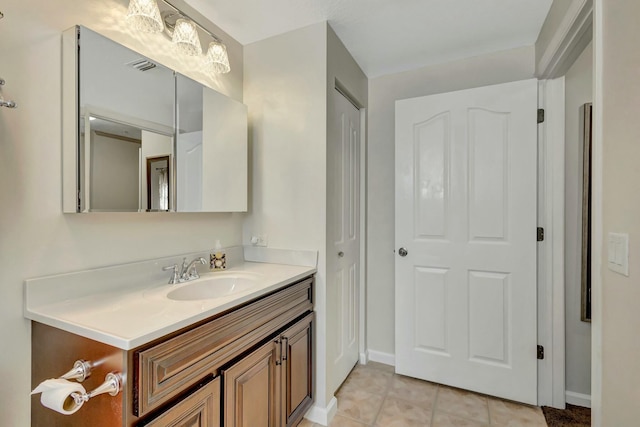 bathroom featuring tile patterned flooring, visible vents, baseboards, and vanity