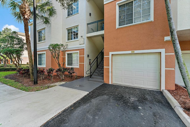 view of front of home with a garage and stucco siding