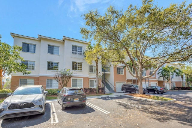 multi unit property with uncovered parking and stucco siding