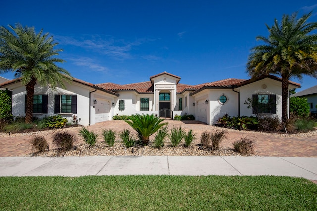 mediterranean / spanish-style home featuring a garage