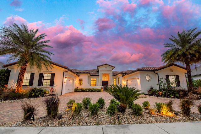 mediterranean / spanish-style home with a garage