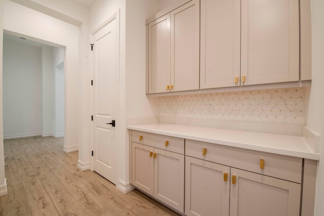 interior space featuring light hardwood / wood-style floors and backsplash