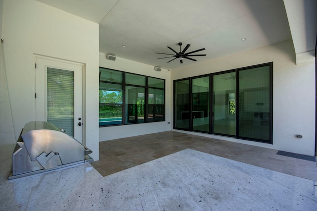 view of patio featuring ceiling fan