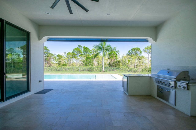 view of swimming pool with a patio area, area for grilling, an outdoor kitchen, and ceiling fan