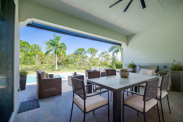 view of patio with ceiling fan, area for grilling, and an outdoor living space