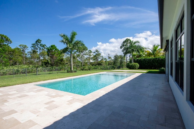 view of swimming pool featuring a lawn and a patio