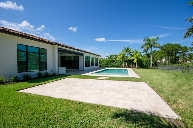 view of pool featuring ceiling fan, a yard, and a patio area