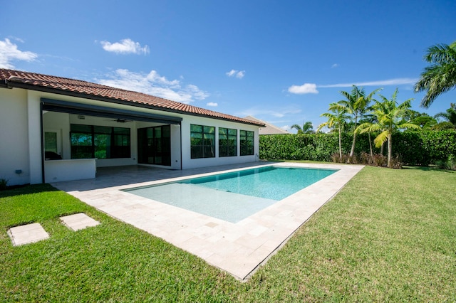 view of pool featuring ceiling fan, a lawn, and a patio area