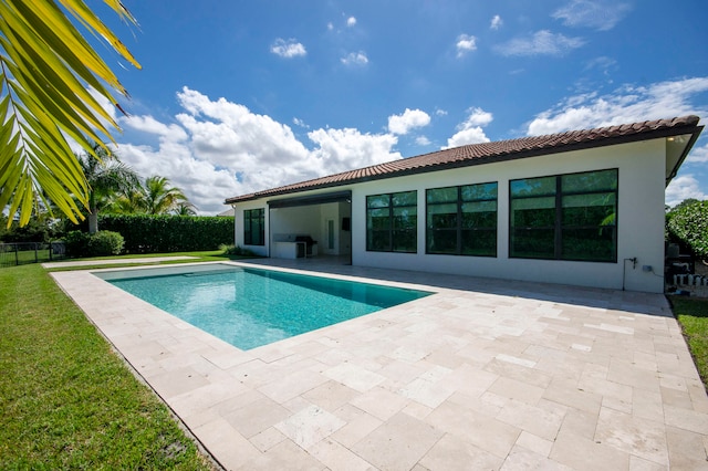 view of pool featuring grilling area, a patio, and a yard