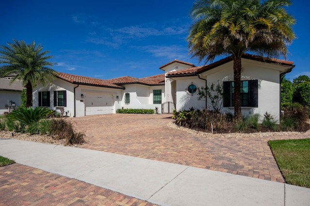 mediterranean / spanish home featuring a garage