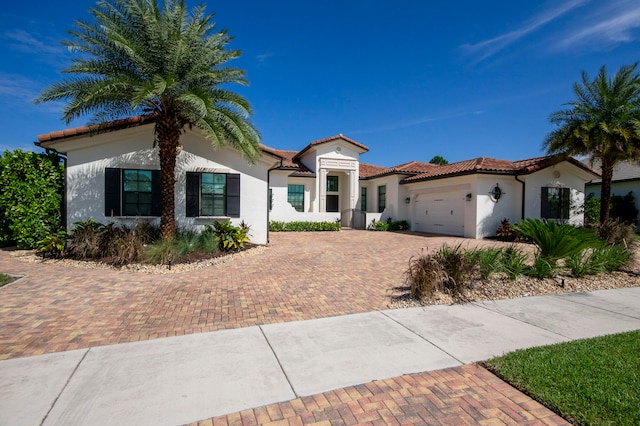 mediterranean / spanish house featuring a garage