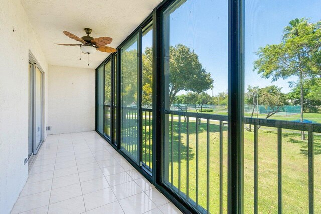 bedroom with ceiling fan, access to exterior, light wood-type flooring, and a textured ceiling