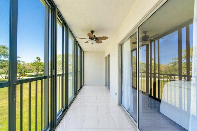 unfurnished sunroom with ceiling fan and a healthy amount of sunlight