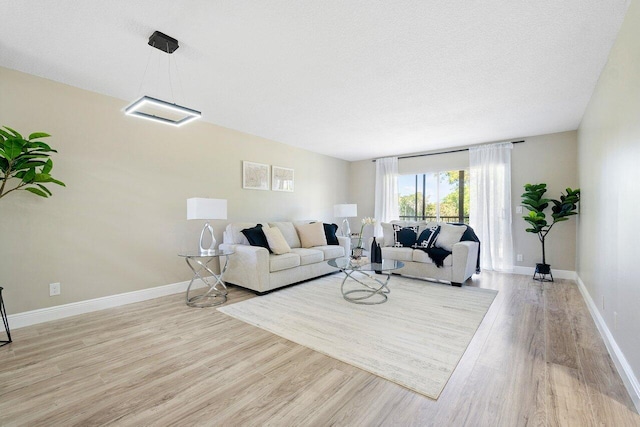 clothes washing area featuring a textured ceiling and stacked washer and clothes dryer