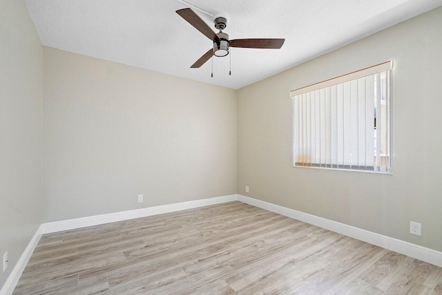 living room featuring a textured ceiling and light hardwood / wood-style flooring