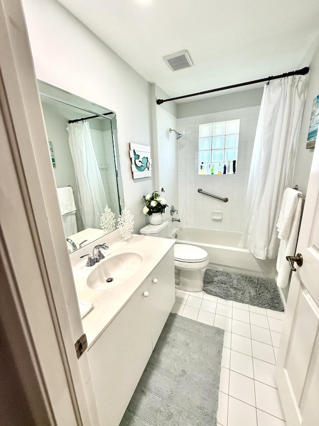 full bathroom featuring vanity, toilet, tile patterned flooring, and shower / tub combo