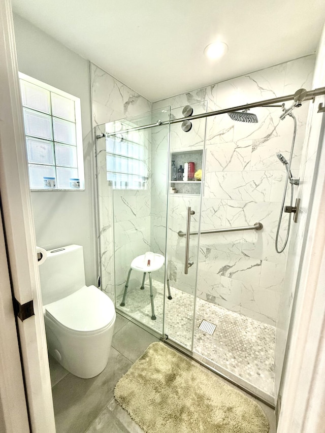 bathroom with walk in shower, toilet, and concrete floors