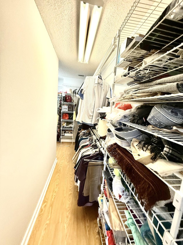 spacious closet featuring hardwood / wood-style floors