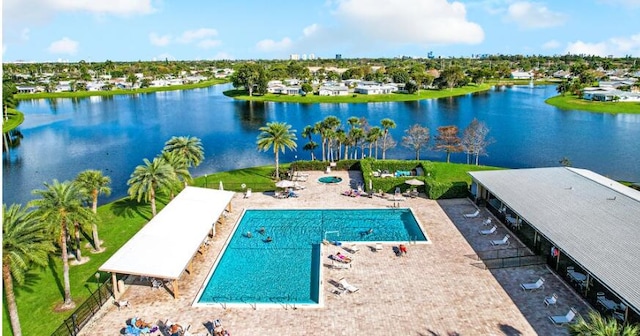 view of swimming pool featuring a water view