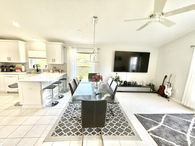 tiled dining room with sink and ceiling fan