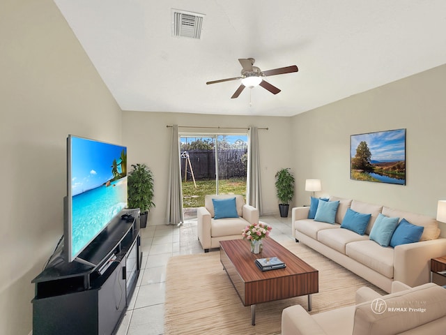 living room with light tile patterned flooring, ceiling fan, and lofted ceiling