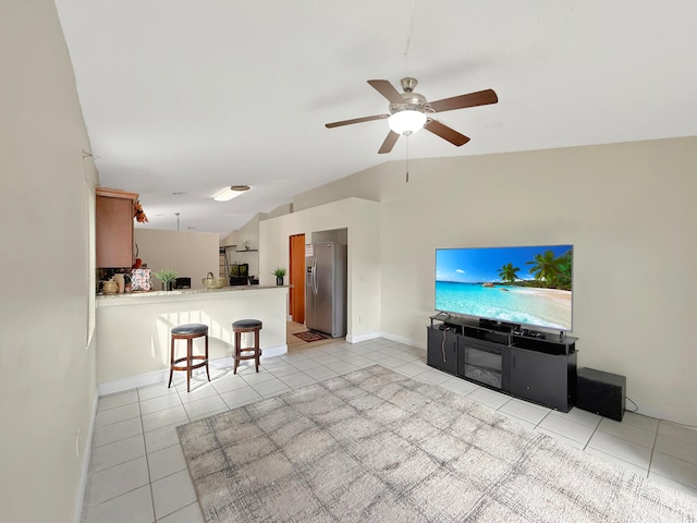 tiled living room with lofted ceiling and ceiling fan