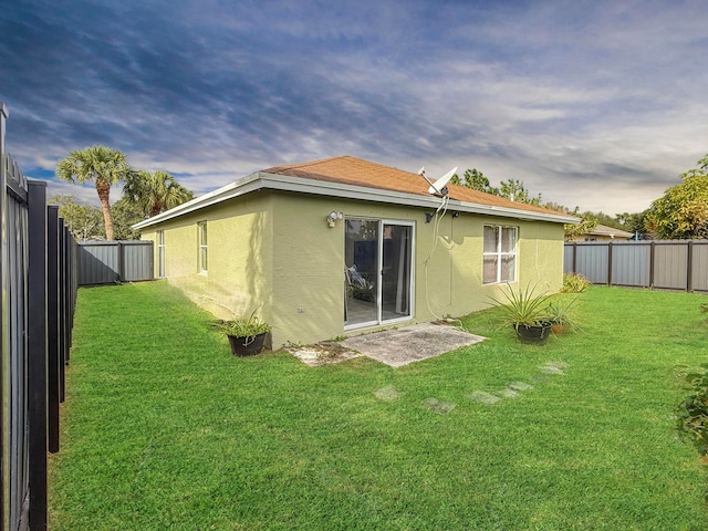 back of house with a lawn