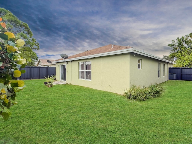 rear view of house with a yard