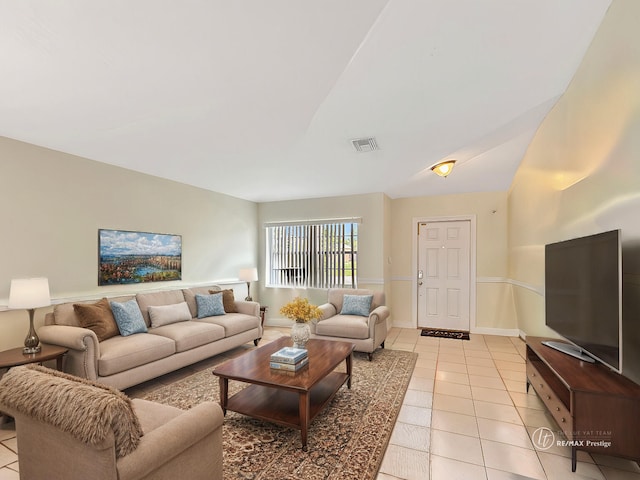 living room featuring light tile patterned floors and lofted ceiling