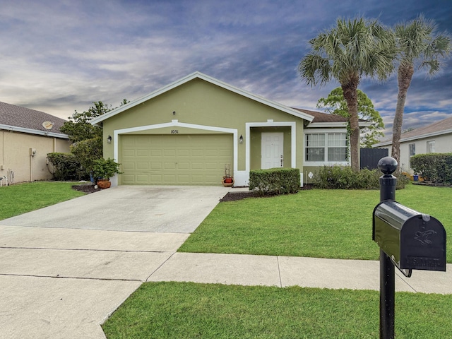 ranch-style house with a garage, driveway, a front lawn, and stucco siding