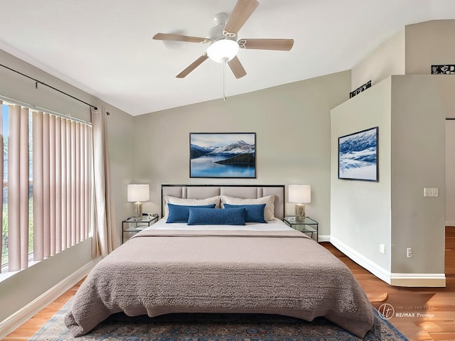 bedroom with hardwood / wood-style flooring, ceiling fan, and vaulted ceiling