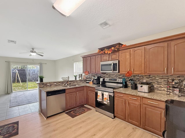 1051 Park Hill Dr, West Palm Beach, FL 33417 - kitchen featuring a peninsula, visible vents, a sink, and appliances with stainless steel finishes