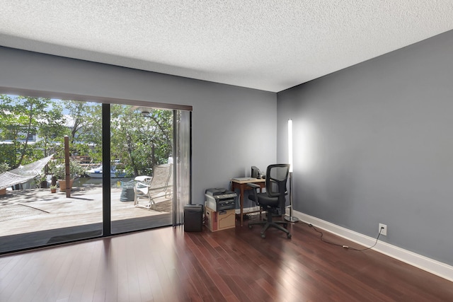office area featuring baseboards, a textured ceiling, and wood finished floors