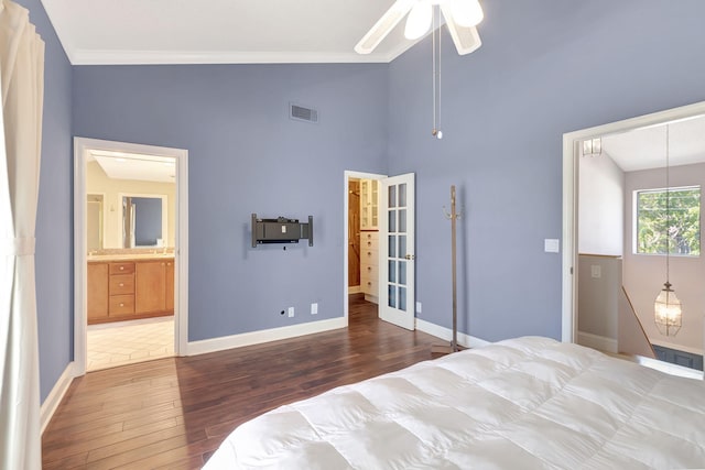 bedroom with dark hardwood / wood-style floors, ornamental molding, vaulted ceiling, ensuite bathroom, and ceiling fan