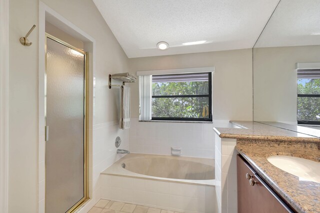 bathroom with a wealth of natural light, vanity, and plus walk in shower