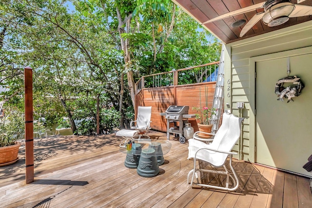wooden terrace with grilling area and ceiling fan