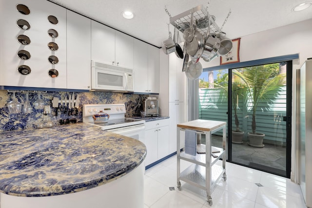 kitchen featuring decorative backsplash, dark countertops, white appliances, recessed lighting, and white cabinets