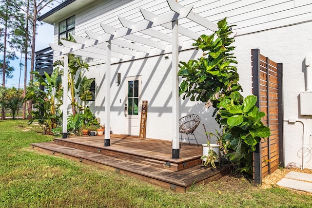 wooden deck featuring a pergola and a yard