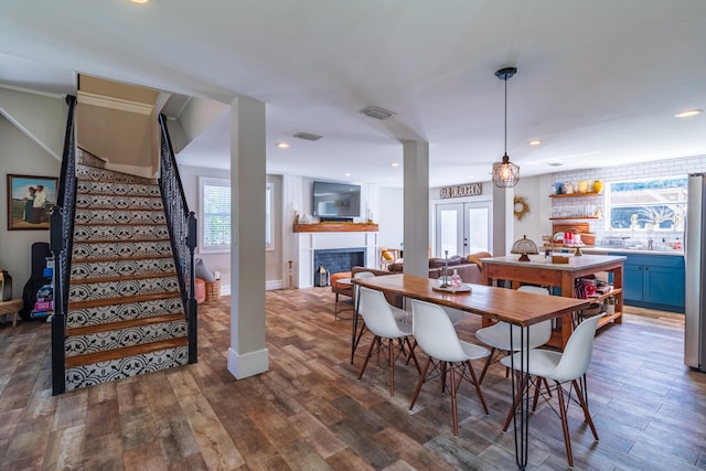 dining space with crown molding, french doors, and dark wood-type flooring