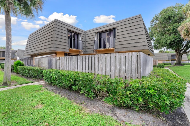 view of side of property with a lawn